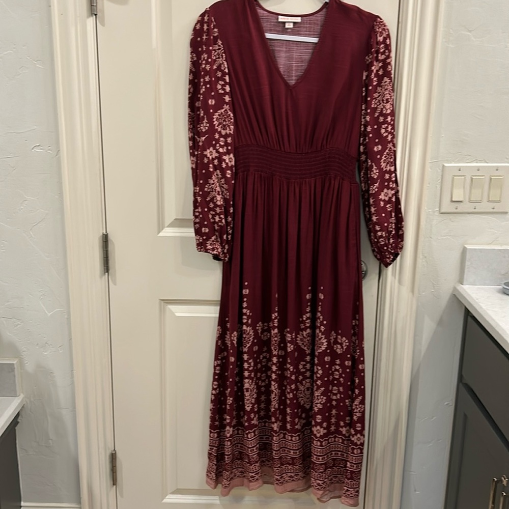 Women’s long sleeve smocked maxi dress with pockets.